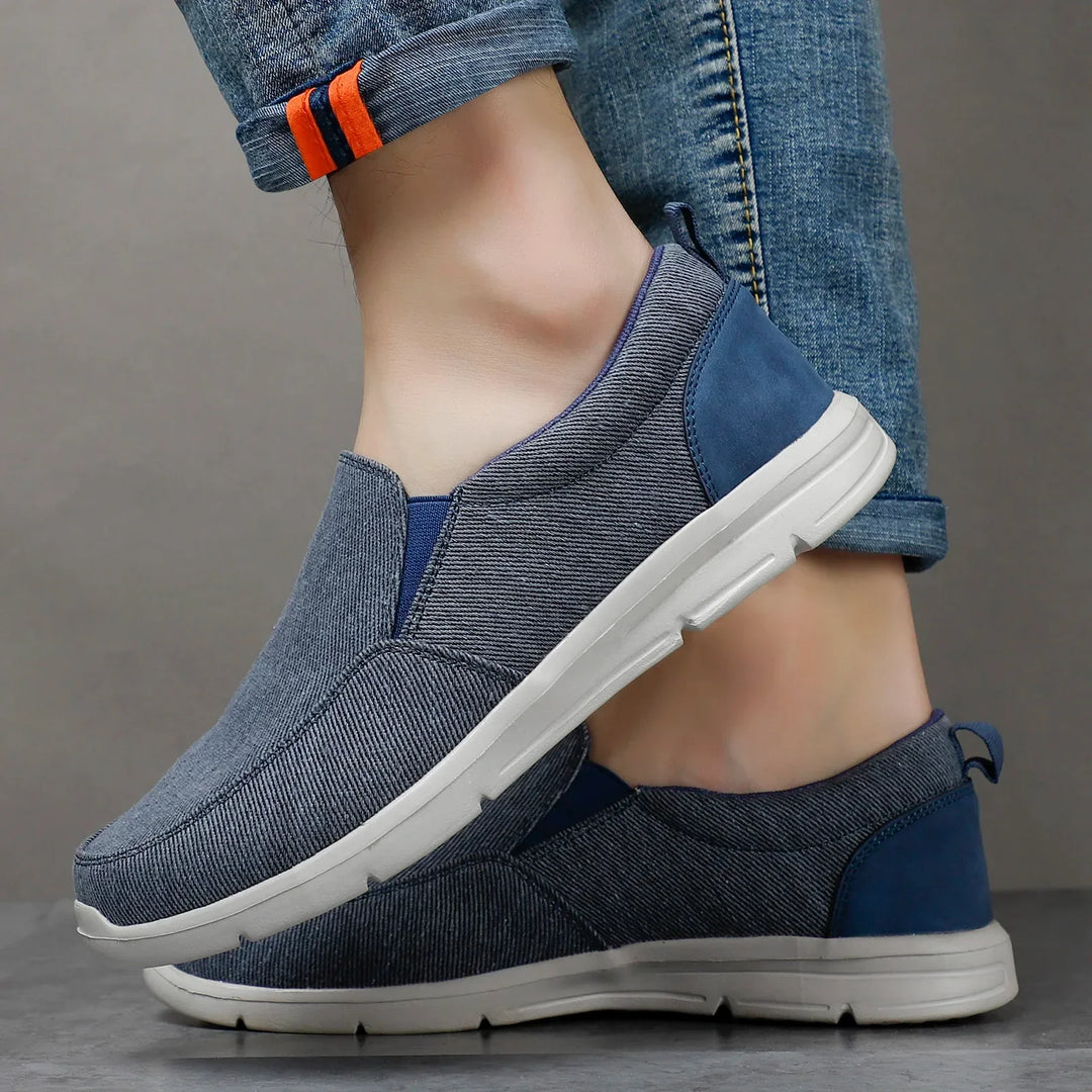 Rovelli casual blue slip-on shoes with white soles, worn with rolled-up jeans