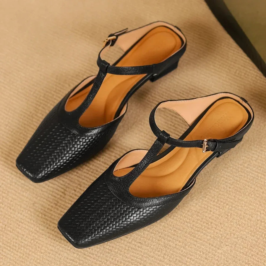 Rovelli black woven leather T-strap flat shoes with square toe on beige background