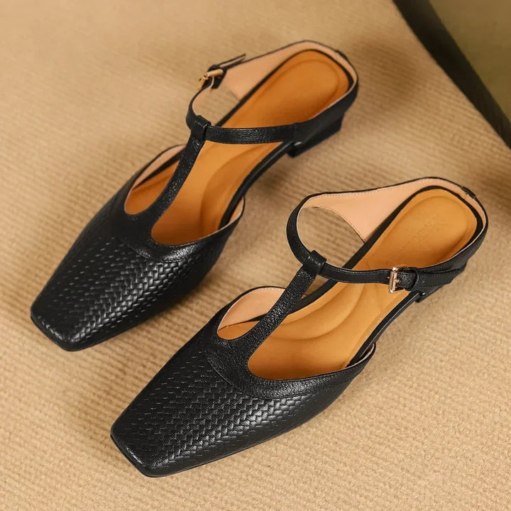 Rovelli black woven leather T-strap flat shoes with square toe on beige background