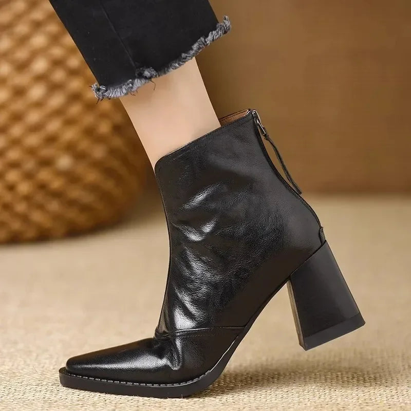 Rovelli black leather ankle boot with block heel, side zipper, and pointed toe