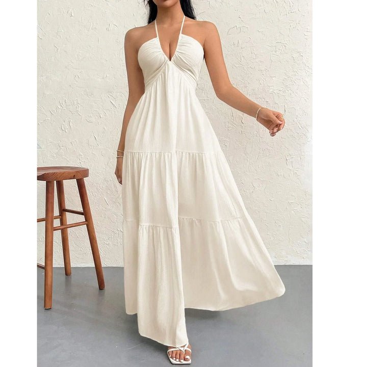 Woman wearing sleeveless white halter maxi dress, summer fashion by Rovelli