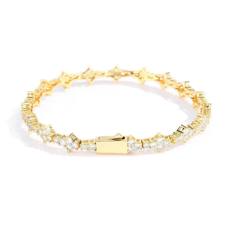 Rovelli gold tennis bracelet with round and baguette diamonds on white background