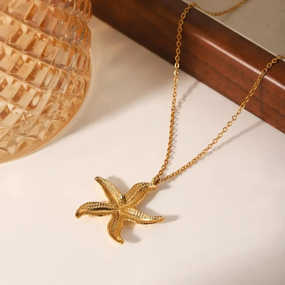 Gold starfish pendant necklace on chain, elegant seashell jewelry by Rovelli