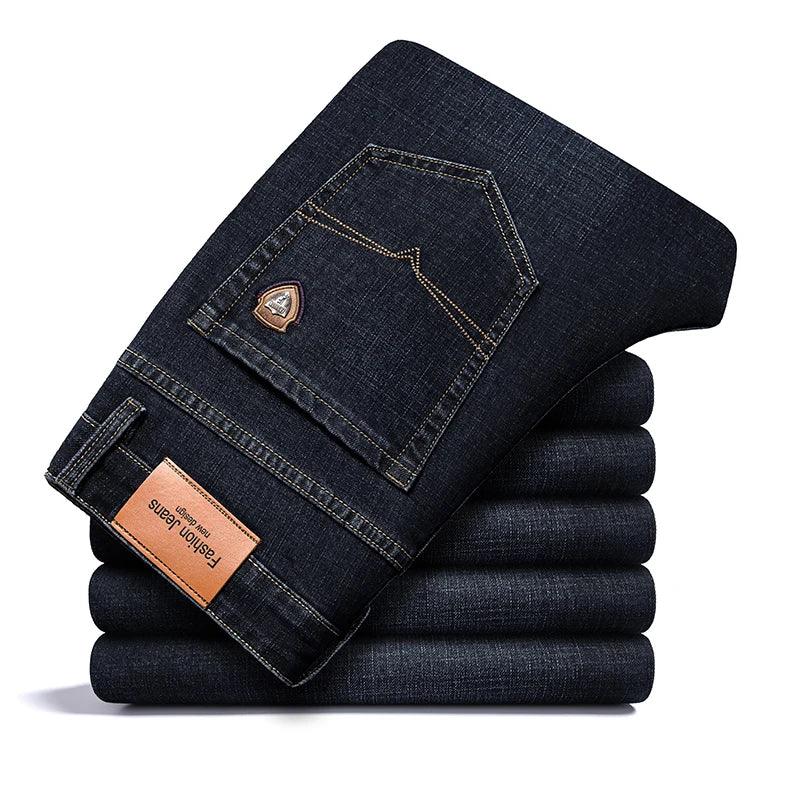 Stack of folded Rovelli dark blue denim jeans with brown label and back pocket detail