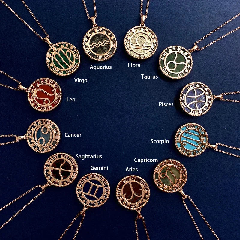Twelve gold astrology jewelry zodiac necklaces arranged in a circle on a dark blue background, each labeled with its astrological sign name, including Aquarius, Libra, Taurus, Pisces, Scorpio, and others.