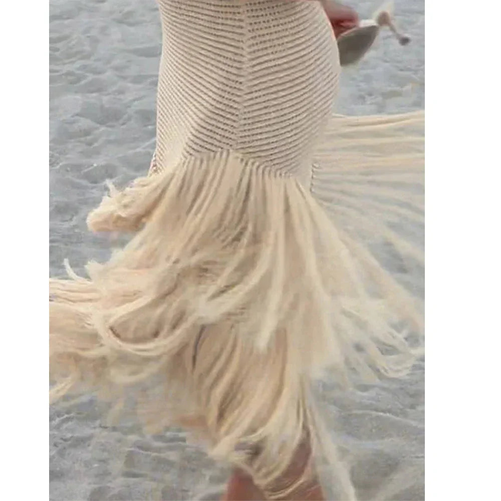 Rovelli beige crochet dress with fringe details, worn at the beach on sand