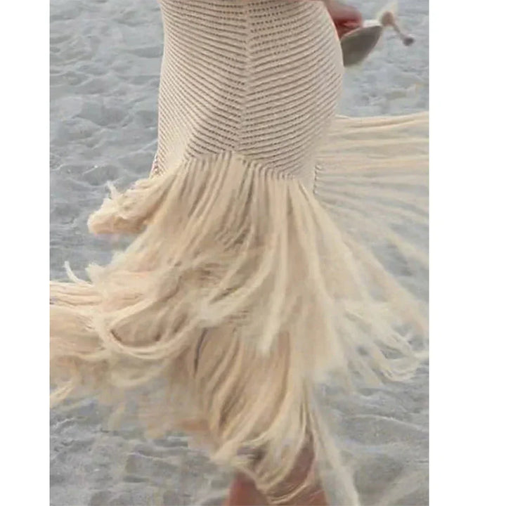 Rovelli beige crochet dress with fringe details, worn at the beach on sand