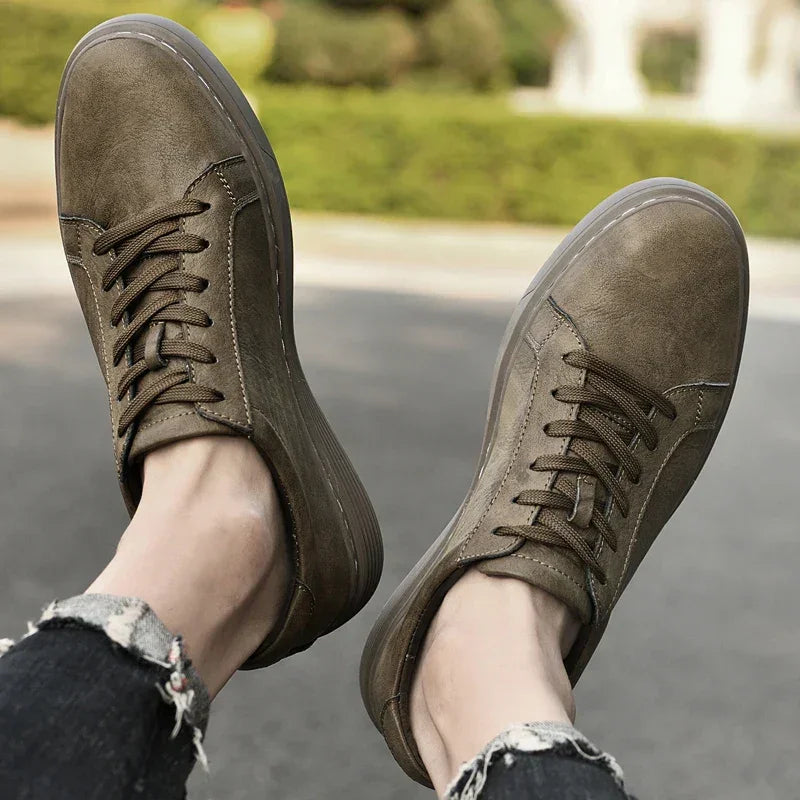 Rovelli olive green casual sneakers on feet outdoors, paired with distressed jeans