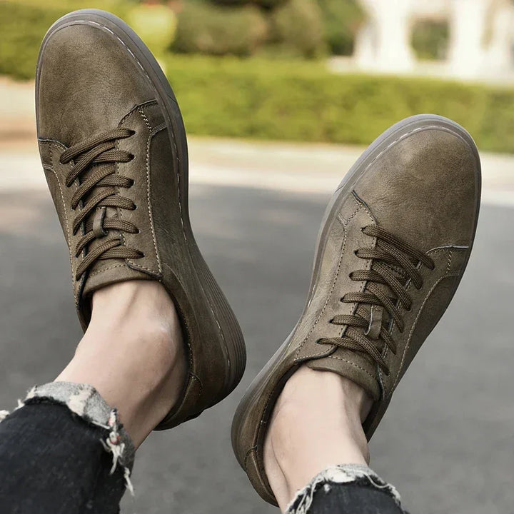 Rovelli olive green casual sneakers on feet outdoors, paired with distressed jeans