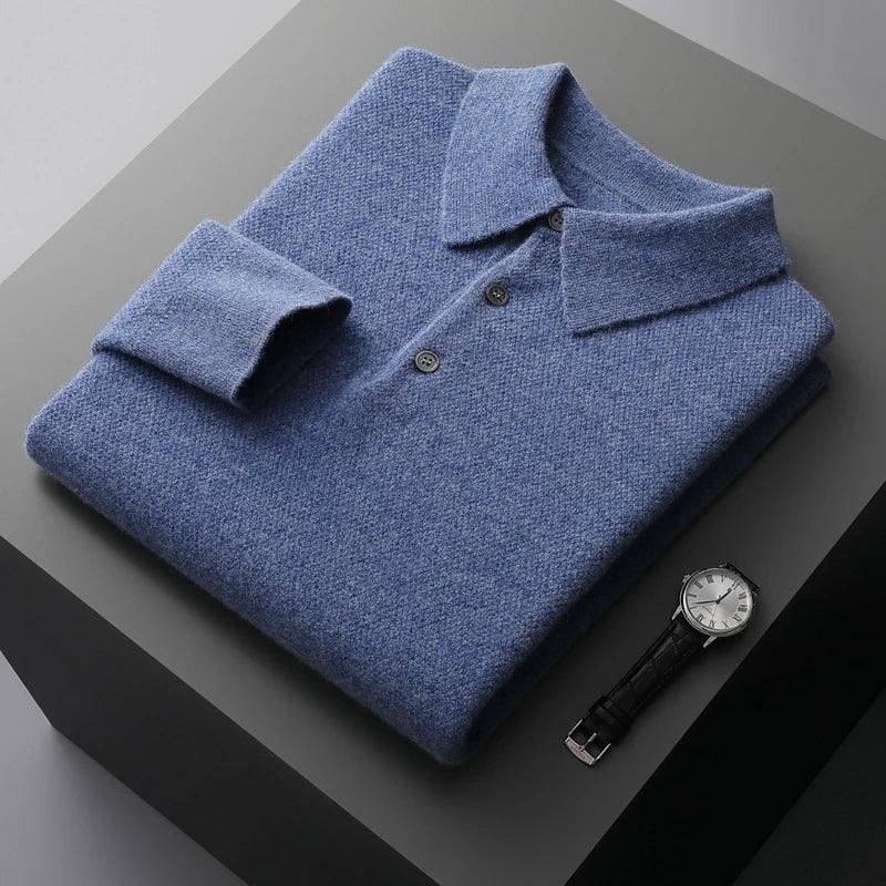 Folded blue knit polo sweater with buttons beside a wristwatch on a gray surface, Rovelli