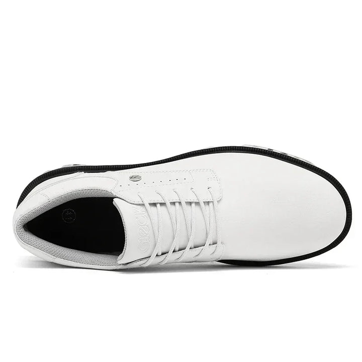 A top view of a white lace-up shoe with a black sole, featuring a smooth upper design, minimal stitching details, and a high-traction outsole for superior grip.