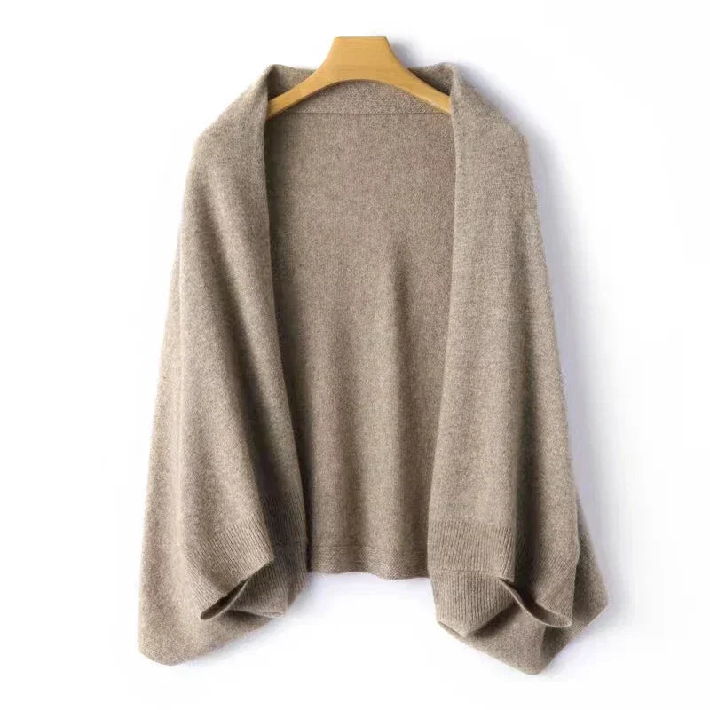 A loose, light brown cashmere blend knit cardigan with wide sleeves is displayed on a wooden hanger against a plain white background—perfect for autumn winter layering.