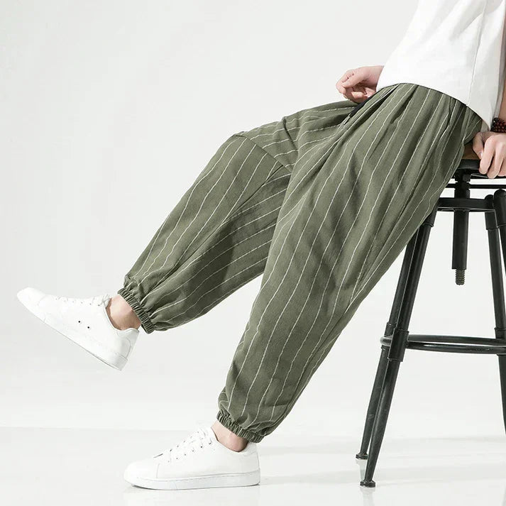 Rovelli olive green striped relaxed linen pants with elastic cuffs, styled with white sneakers