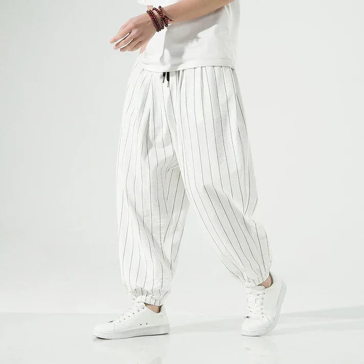 Rovelli white pinstripe harem pants with drawstring waist and white sneakers