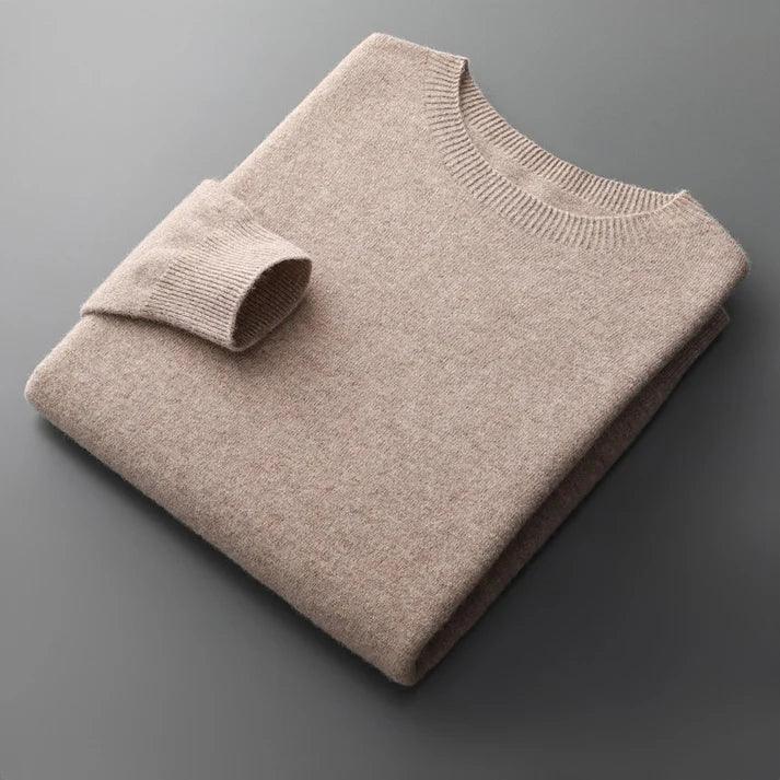 Folded beige knit sweater with crew neck on gray surface, Rovelli clothing