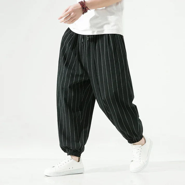 Rovelli black pinstripe casual pants with elastic cuffs, styled with white sneakers