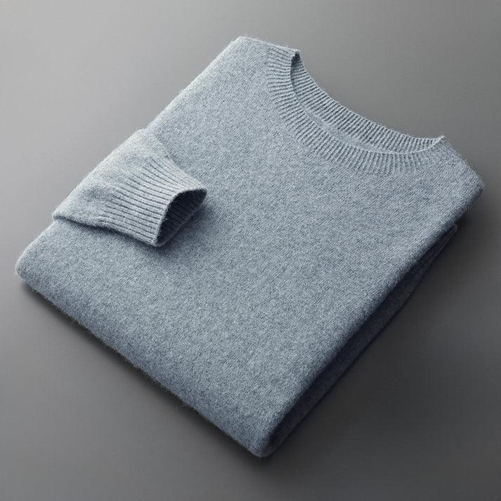 Folded light blue knit sweater from Rovelli on a gray background