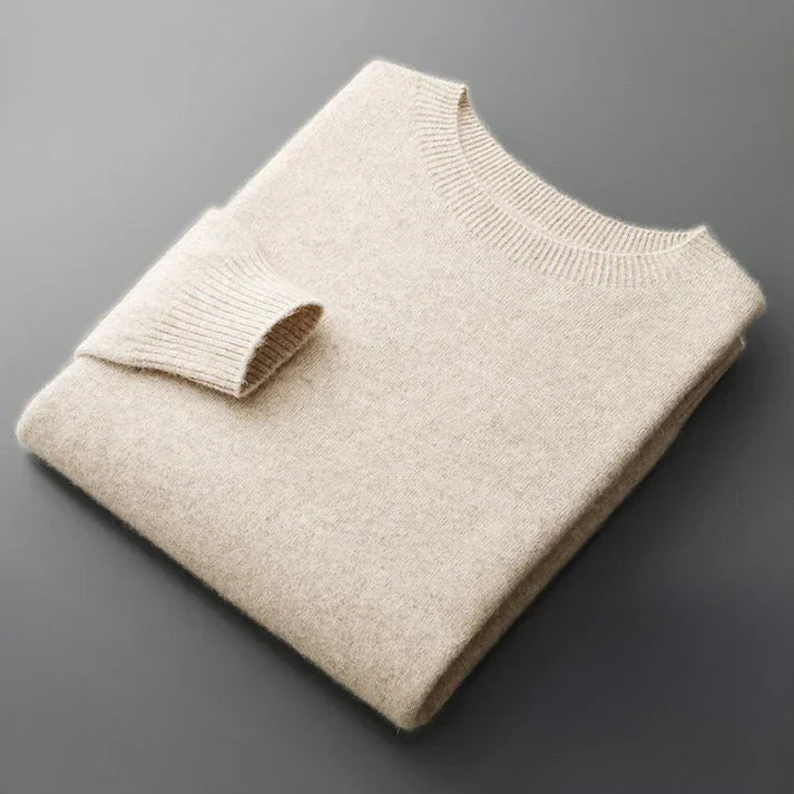 Folded beige cashmere sweater on a gray background, Rovelli knitwear