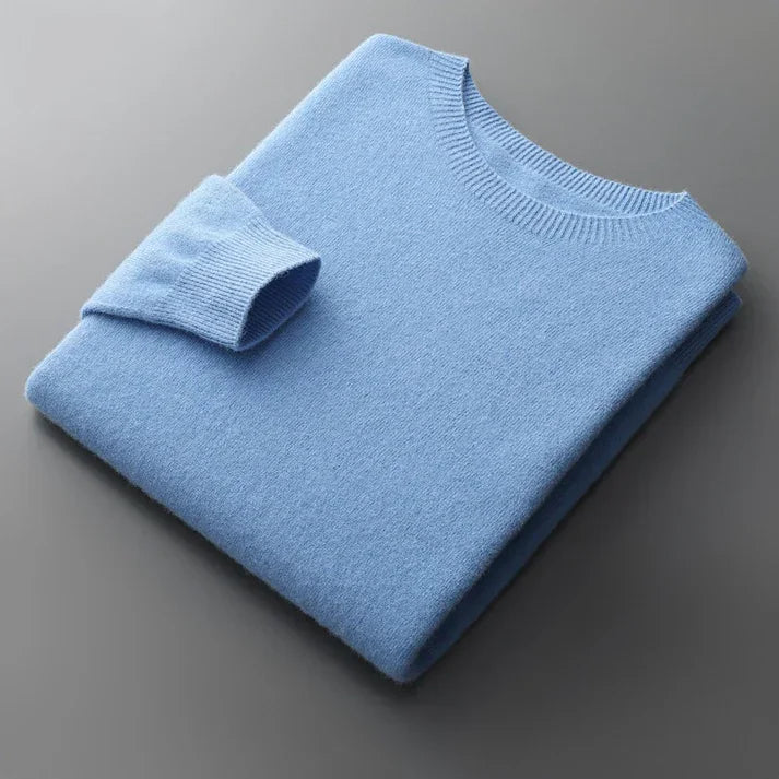 Folded light blue sweater on a gray background, Rovelli fashion apparel