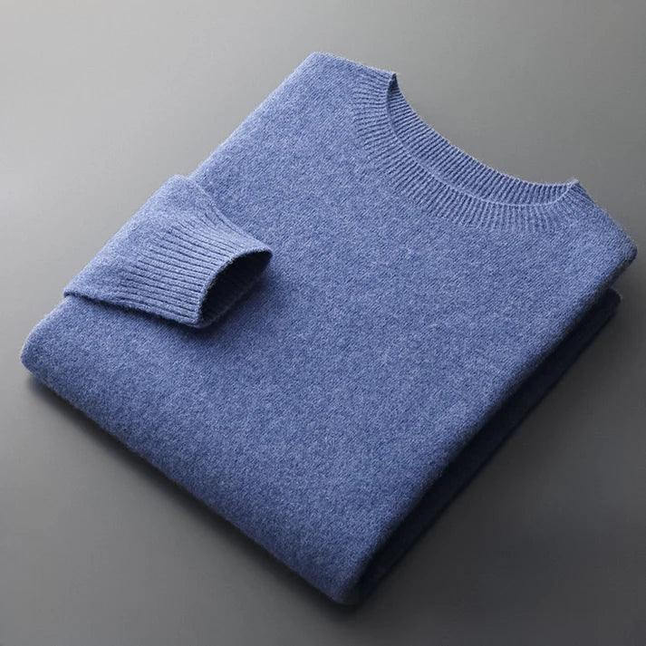 Rovelli blue knit sweater neatly folded on a gray surface