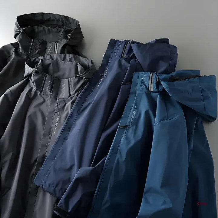 Rovelli lightweight waterproof jackets in black, navy, and blue on a gray background