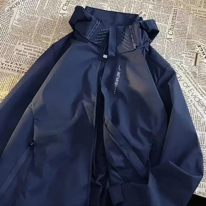 Navy blue Rovelli jacket with hood and zipper, laid on newspaper background