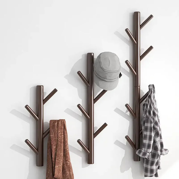 Rovelli modern wall-mounted coat rack set in branch design holding hat, scarf, and shirt
