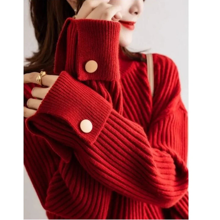 Woman in a Rovelli ribbed red knit sweater with oversized sleeves and gold buttons