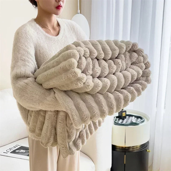 Woman holding soft beige plush blanket in a cozy modern living room, Rovelli home decor.
