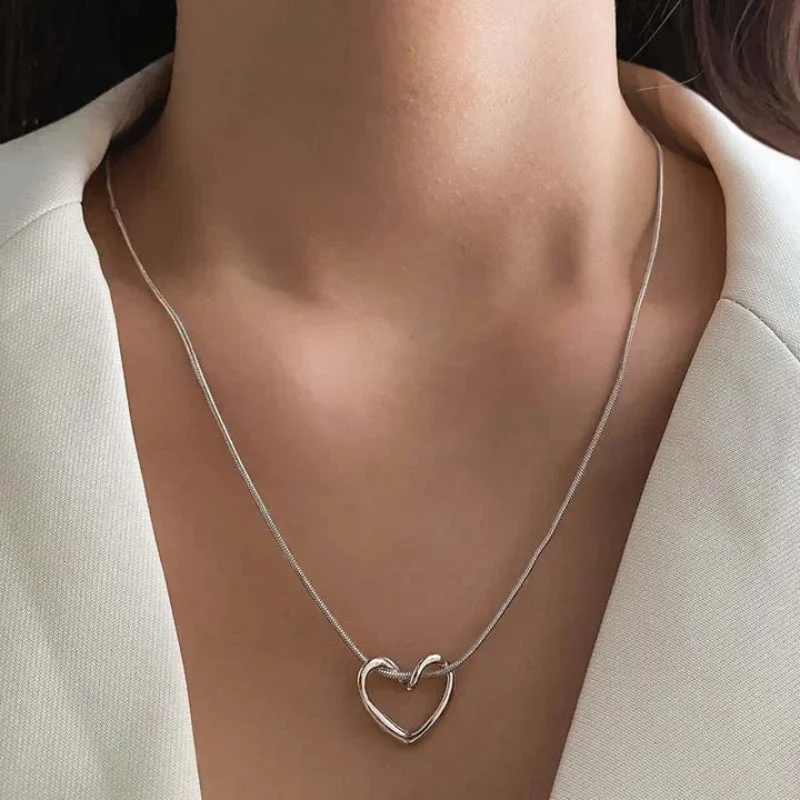 Rovelli silver heart pendant necklace on woman in white blazer