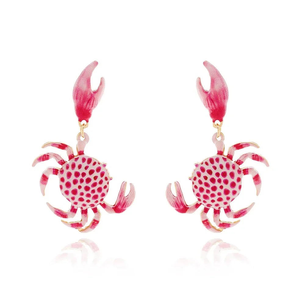 Rovelli pink crab-shaped earrings with red polka dots and detailed claws on white background
