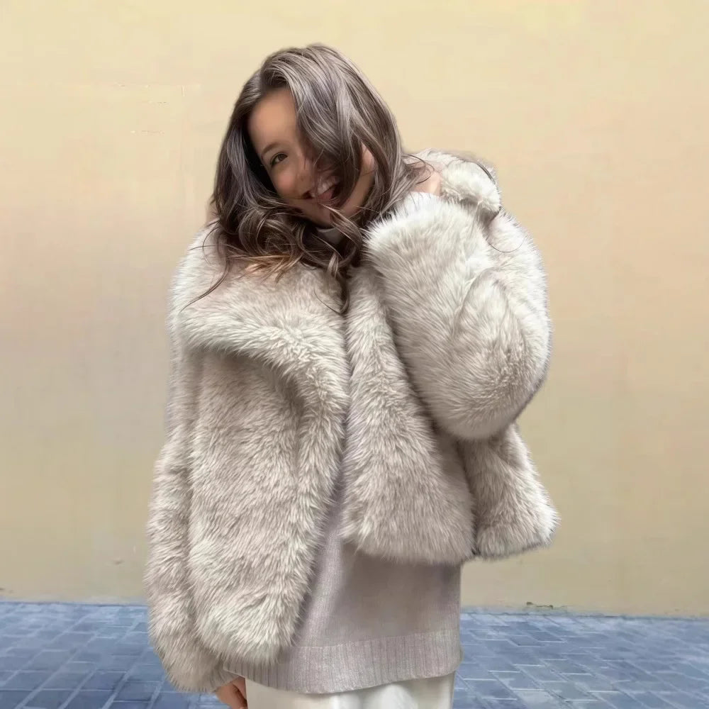 Woman wearing a beige faux fur coat from Rovelli, smiling against a neutral background