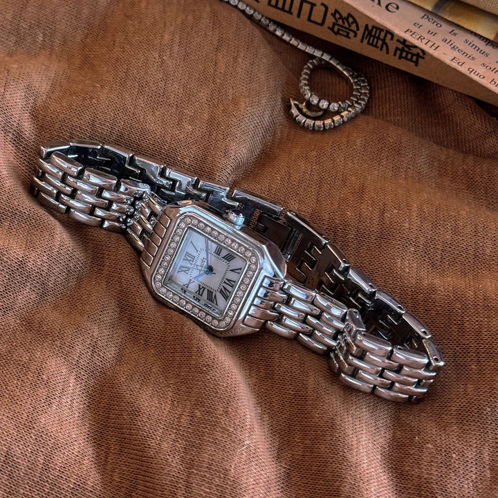 Rovelli luxury silver watch with Roman numerals and crystal bezel on brown fabric