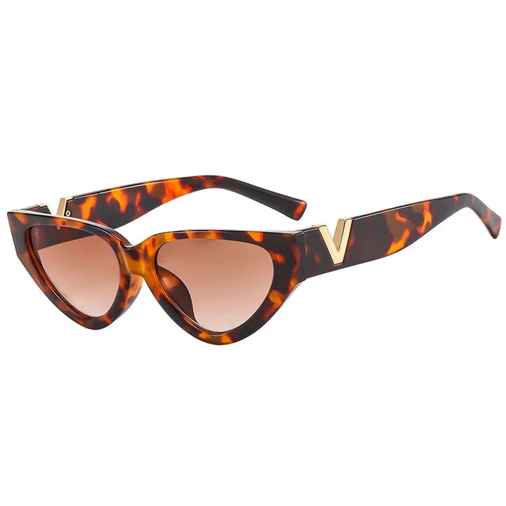 Vintage cat eye sunglasses featuring a bold tortoiseshell frame, brown gradient lenses, and gold V accents on the upper corners, offering stylish UV400 protection.