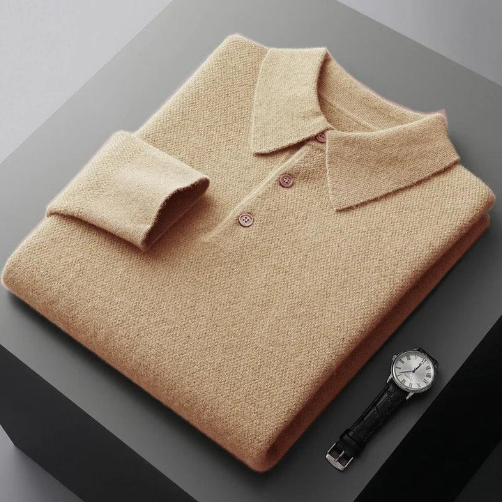 Rovelli beige knit polo sweater folded on gray table next to classic black leather watch