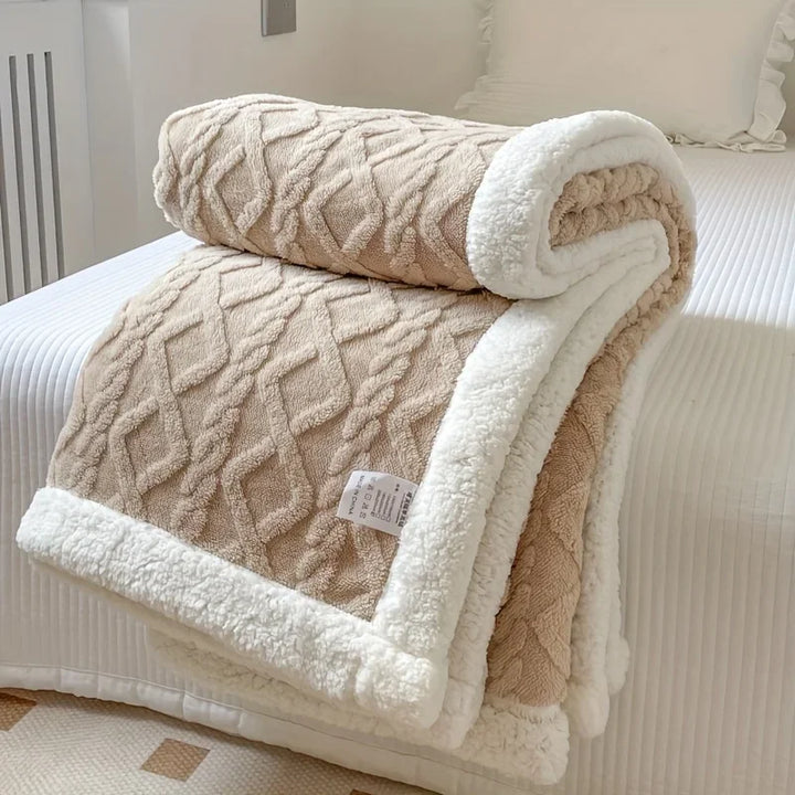 Beige textured fleece throw blanket with white sherpa trim on bed, Rovelli home decor