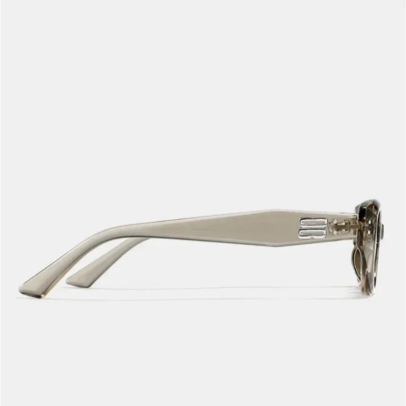 Side view of beige sunglasses with a thick, translucent acetate frame and wide arms featuring a subtle hinge detail. The lenses offer UV400 protection. Background is plain white.