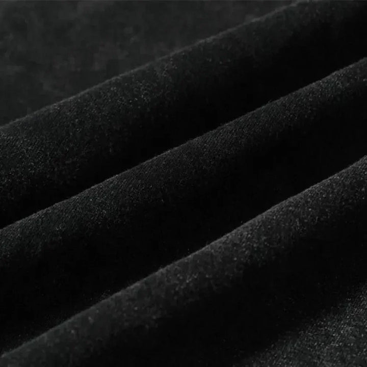 Close-up of black velvet fabric with soft texture, showing ridges and folds that highlight its smooth, luxurious surface—ideal for graphic design projects or pairing with an oversized fit.