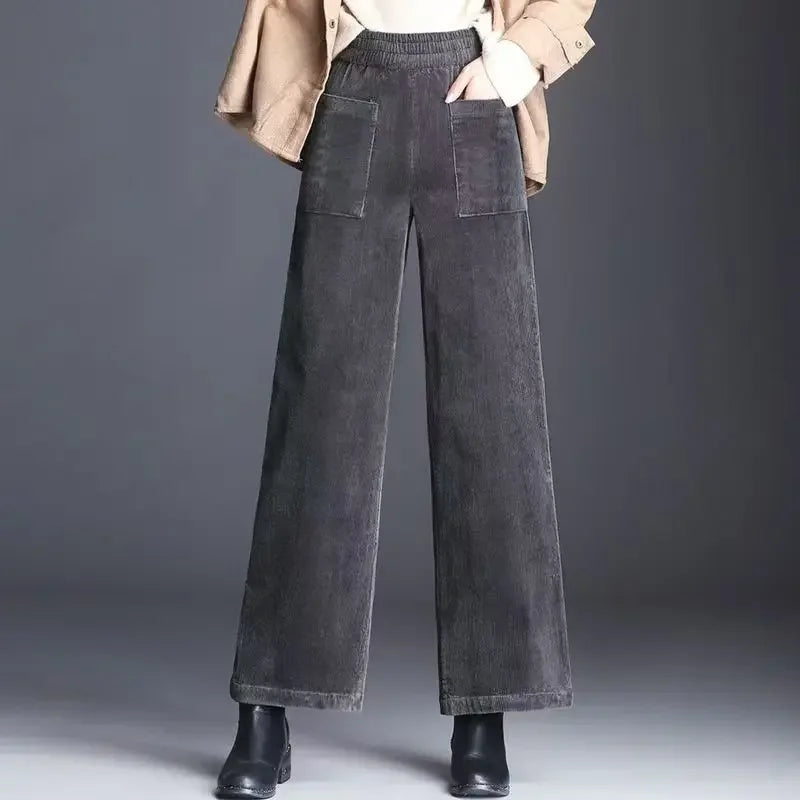 Wide leg gray corduroy pants with patch pockets from Rovelli, styled with boots and jacket