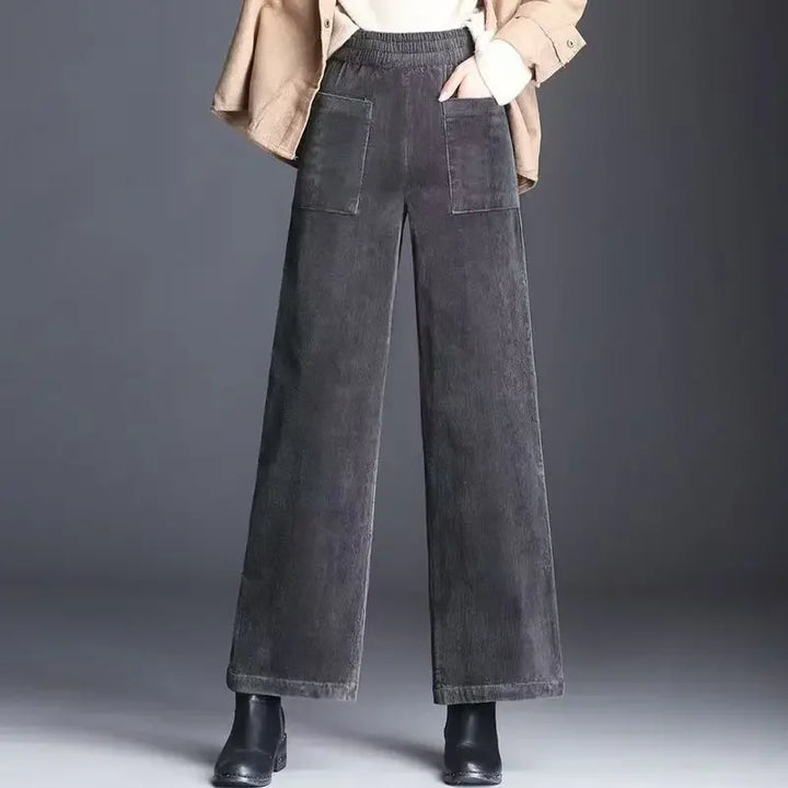 Wide leg gray corduroy pants with patch pockets from Rovelli, styled with boots and jacket