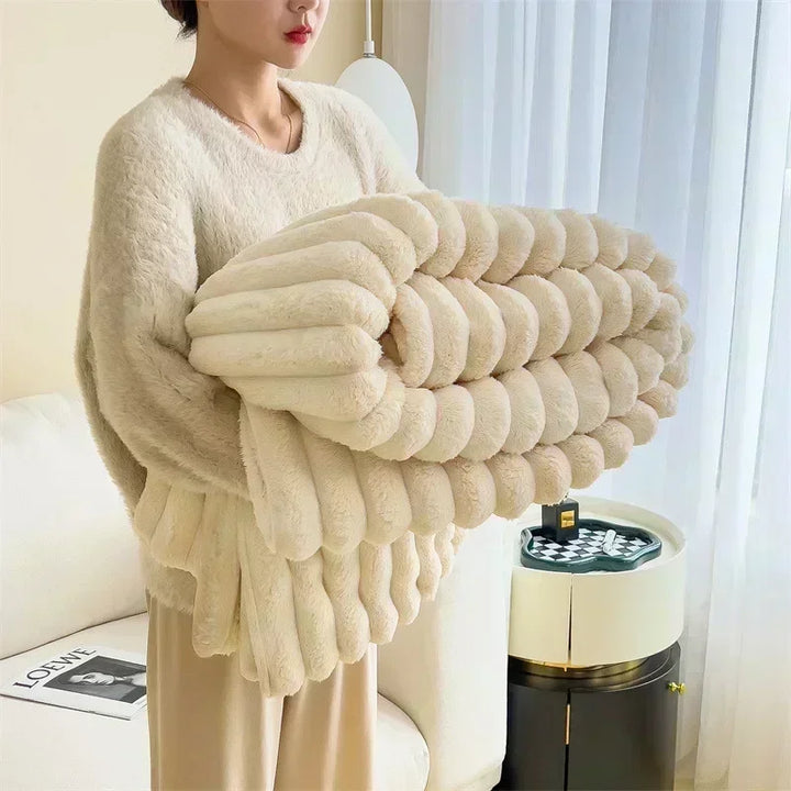 Woman holding a soft beige plush blanket in a modern living room, Rovelli home decor