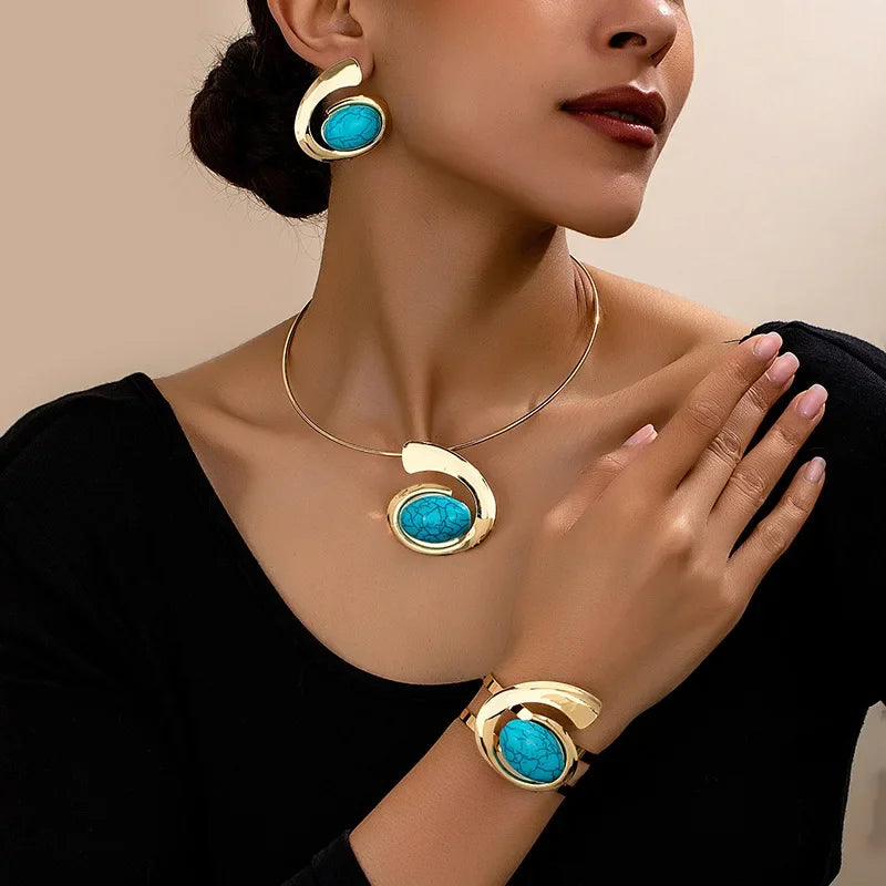 Woman wearing gold and turquoise jewelry set with earrings, necklace, and bracelet by Rovelli