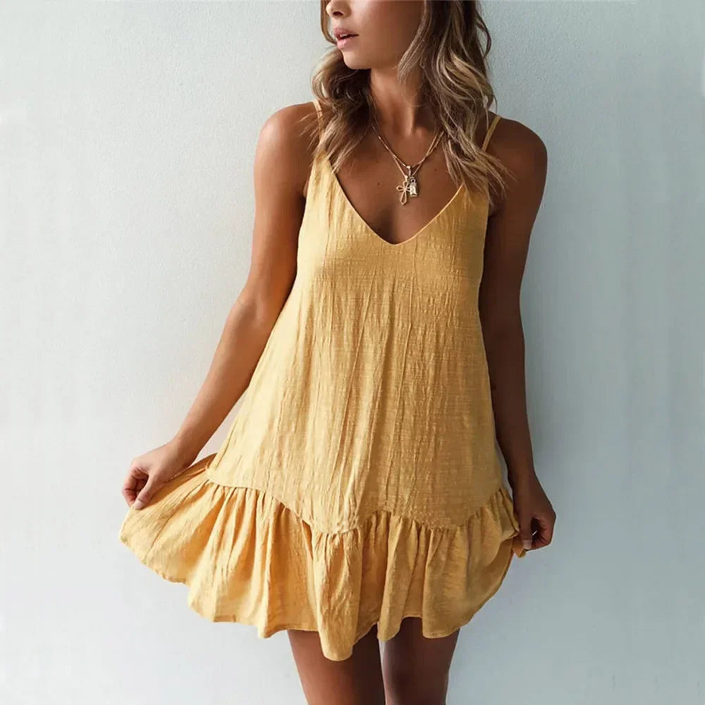 Woman wearing a yellow sleeveless summer dress, V-neck, at Rovelli