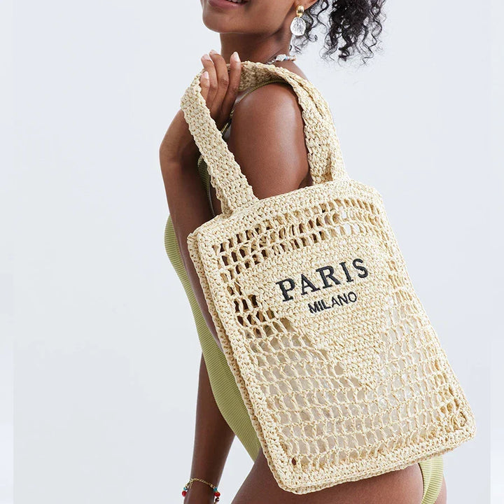 Woman carrying woven straw Paris Milano tote bag, Rovelli fashion accessory