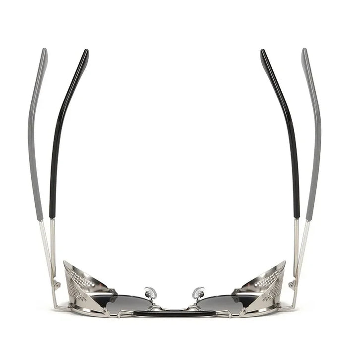 A pair of Steampunk sunglasses viewed from the front with the arms raised, showing silver frames, black tips, and reflective lenses. The design appears futuristic and angular with bold metallic vibes.