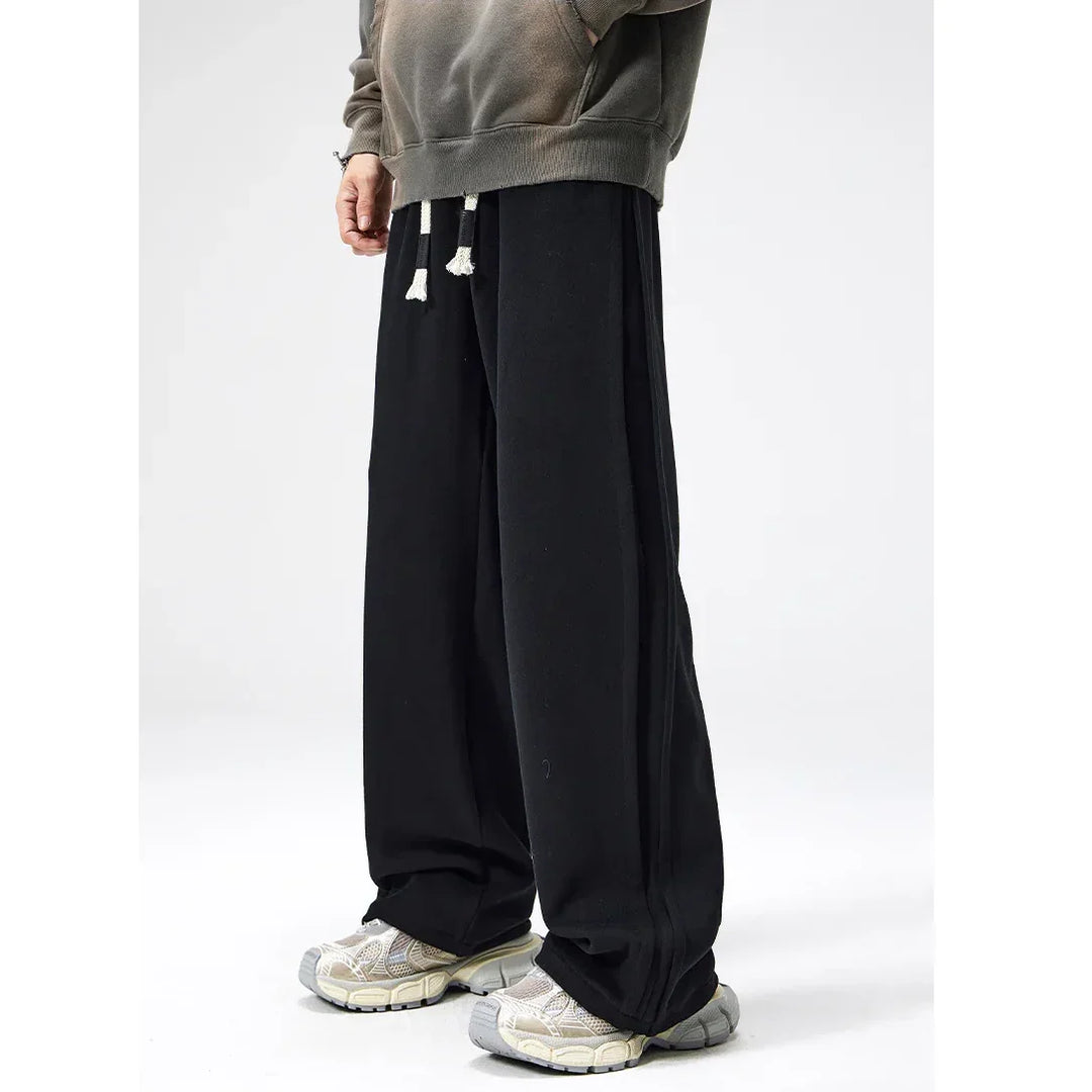 Rovelli wide-leg black sweatpants with drawstring, casual shoes, and a faded hoodie