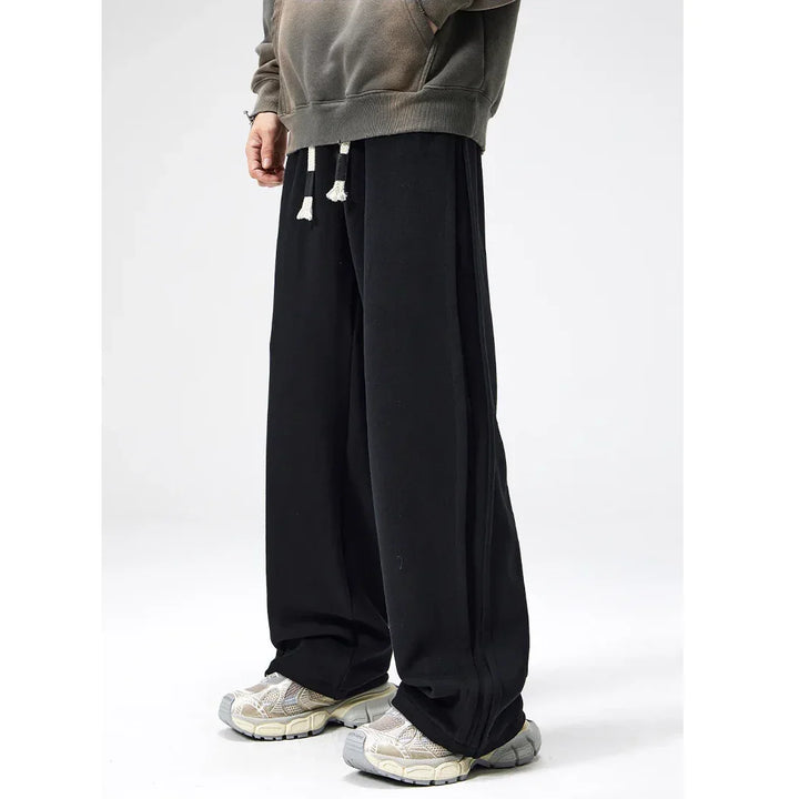 Rovelli wide-leg black sweatpants with drawstring, casual shoes, and a faded hoodie