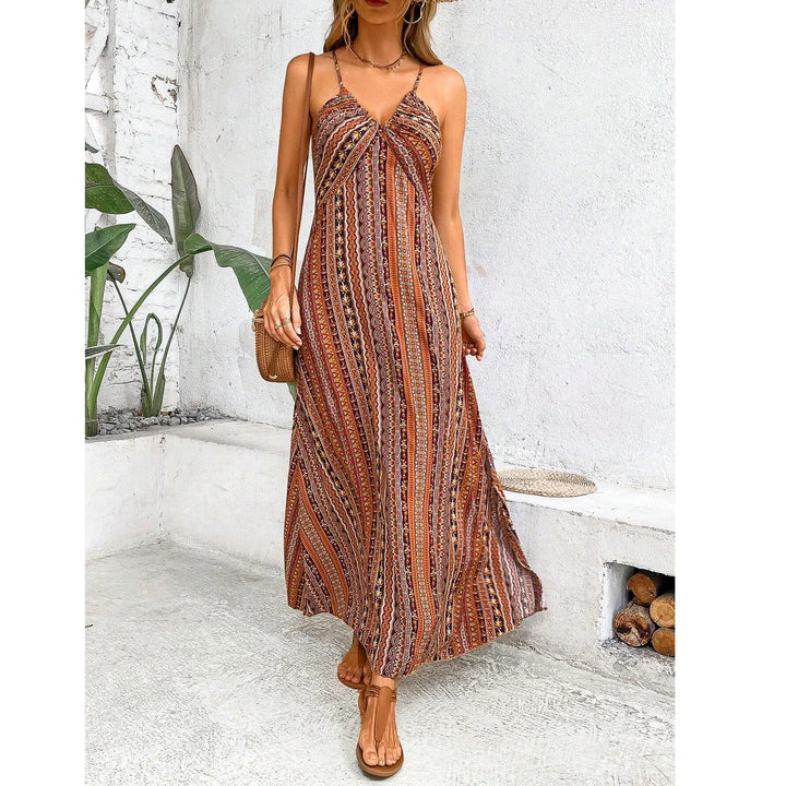 Woman wearing a boho striped maxi dress in a minimal outdoor setting, Rovelli fashion