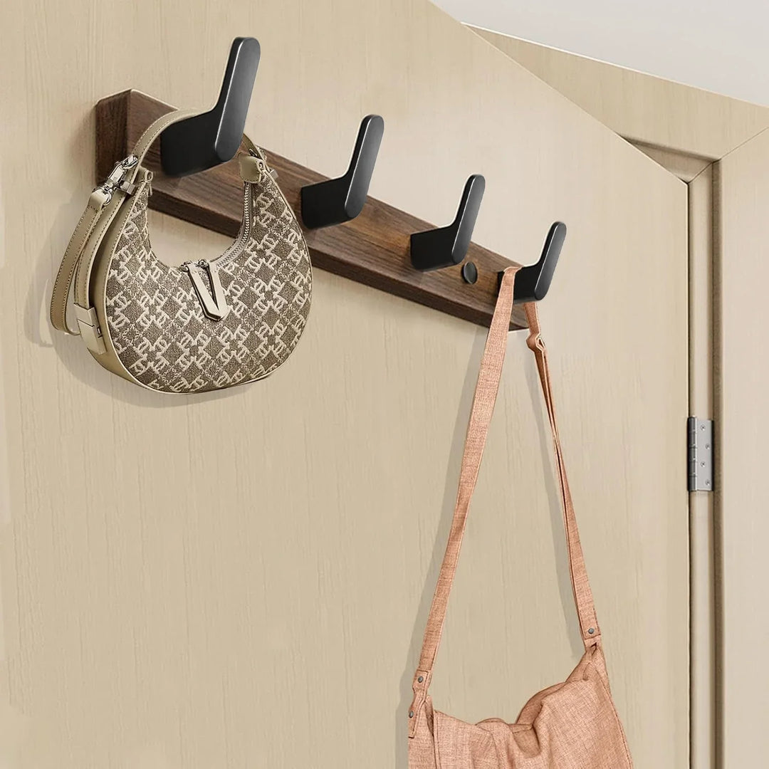 Wooden over door coat rack with black hooks holding two handbags, Rovelli home organizer