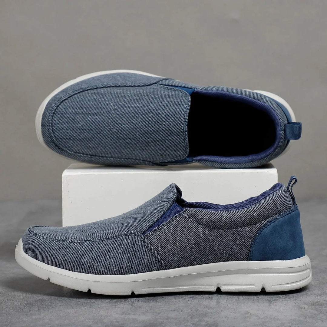 Rovelli men's slip-on blue casual shoes with white sole on gray background